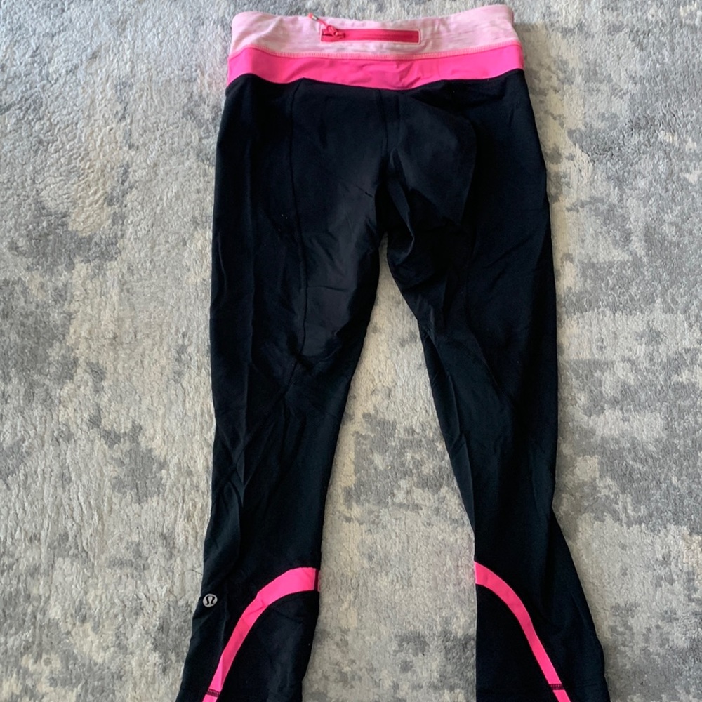 Lululemon mid rise crop leggings in black and hot pink